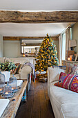 Living room decorated for Christmas with illuminated Christmas tree and presents