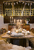 Festive table setting with straw bales in rustic style with candlesticks and garlands