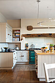 Country kitchen with rustic beam above the cooker