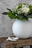 Knot sculpture next to vase with bouquet of flowers