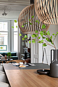 Wooden table with modern pendant lights in the dining room