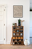 Modern wall decoration above a vintage wooden shelf with accessories