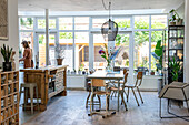 Dining area and rustic kitchen island in a bright living room with large windows