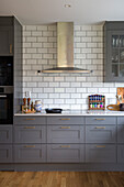 Kitchen with grey cabinets and metro tiles