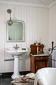 Vintage bathroom with freestanding washbasin and wooden dresser
