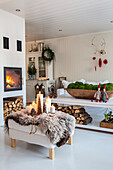 Living room with fireplace, white interior and Christmas decorations