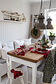 White country-style breakfast table setting with industrial pendant lights