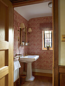 Traditional bathroom with patterned wallpaper and wooden details