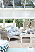 Conservatory with antique upholstered armchair with floral pattern