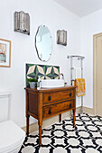 Vintage vanity with modern sink and graphic tiles in the bathroom