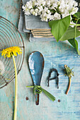 Tin spoon with bow made of grass, with dandelion and letter made of string