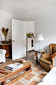 Living room with upholstered armchairs, wooden table and vintage-style decoration