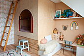 Children's room with loft bed and play area in pastel colors