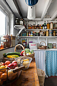 Pantry with baskets full of fresh fruit and vegetables