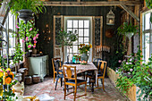 Gartenhaus mit Holztisch, Pflanzen und rustikaler Dekoration