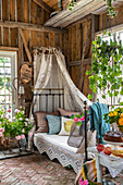 Four-poster bed, ornamental plants and vintage decor