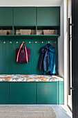 Wardrobe in green with storage space and bench with upholstery