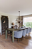 Rustic dining table with grey chairs and pendant light in the dining room
