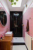 Shower cubicle with pink and black wall tiles