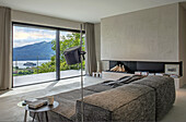 Living room with panoramic window and view of the mountains and lake