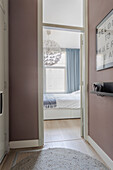 View of the bedroom with hanging ball light and blue curtains