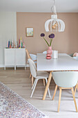 Dining room with pastel-colored walls, modern chairs and large table