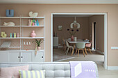 Open-plan living and dining area with pastel-colored decorations