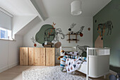 Children's room with animal motifs on the walls and white children's bed