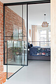 Bedroom with glass wall, brick wall and bed