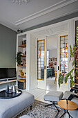 Living room with open sliding door and view into dining room