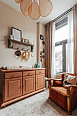 Wooden changing table and rustic armchair in cozy children's room