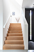 Modern staircase with light-colored wooden staircase