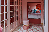 Retro bedroom with mirrored wardrobe and cozy sleeping alcove in shades of pink and blue