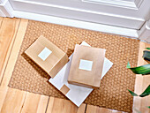 Delivered boxes on a doormat at the entrance to a flat