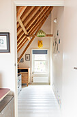 View of room with wooden beams and sloping ceiling