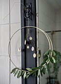 Round metal wreath with olive branches and decorations