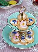 Etagere with cookies decorated with edible flowers