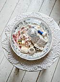 Bowl with sewing bits and bobs on crocheted doily