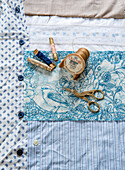 Sewing items on fabric with bird motif