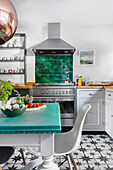 Kitchen with green wall tiles and tiled floor with star pattern