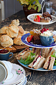 Etageren with sandwiches, scones and pastries for afternoon tea