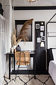 Workplace with rattan chair and decorative grasses in the bedroom