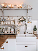 Crockery rack with Christmas decorations above kitchen counter