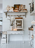 Table and wall shelf in shabby chic style with Christmas decorations