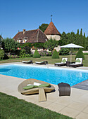 Pool with elegant loungers in the garden