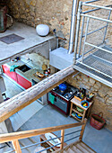 View from above of the kitchen in a loft with natural stone wall