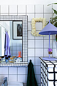 Bathroom with white tiled wall and mosaic mirror