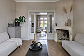 Living room with fireplace, glazed sliding doors and herringbone parquet flooring