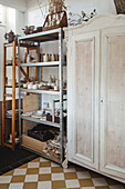 Ceramic studio with shelf for pottery and antique wardrobe