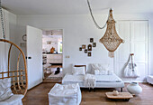 Bright living room with hanging chair and macramé ceiling light